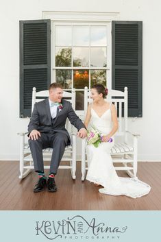 a bride and groom sitting in front of an open window at their wedding reception on the porch