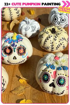 painted pumpkins with skulls and flowers on them