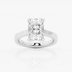 a square cut diamond ring on a white background