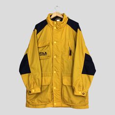 Vintage 90s Fila Sport Bomber Parka Jacket XLarge Fila Ski Wear Snowboarding Yellow Jacket Fila Winter Snow Gear Ski Suit Hoodie Coat XL Please contact me for any questions about this clothing before buying. Size on tag : None but fits like Size XL (check measurements below) Measurement : Armpit to armpit : 26" inches Back collar to hem (total length) : 34" inches Weight : 1.01 kg Condition : Good Condition. No holes and no stains. Delivery / Postage :- DHL EXPRESS / EXPEDITED = 3-5 business day Vintage Windbreaker With Detachable Hood, Vintage Windbreaker With Detachable Hood For Outdoor, Vintage Parka With Detachable Hood For Streetwear, Vintage Streetwear Parka With Pockets, Vintage Outerwear With Detachable Hood For Streetwear, 90s Style Long Sleeve Hooded Jacket For Fall, 90s Windbreaker For Outdoor Activities, 90s Style Windbreaker For Outdoor Activities, Retro Hooded Outerwear For Streetwear