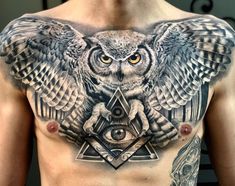 an owl and triangle tattoo on the chest is shown in black and grey colors with yellow eyes