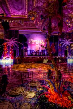 an elaborately decorated ballroom with tables and chairs