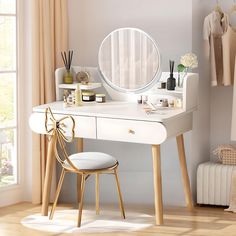 a white dressing table with a mirror, stool and other items on it in front of a window