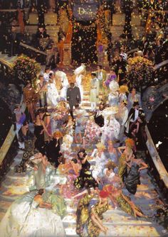 a large group of people standing on top of a boat filled with confetti