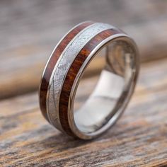 a wedding ring with wood inlays and silver