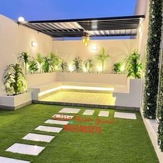 an outdoor living area with grass and potted plants