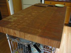 a kitchen island that has some utensils on it and is in the middle of a stainless steel rack