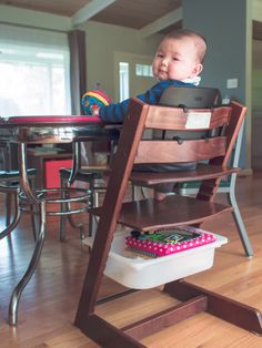 a baby is sitting in a high chair