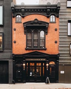 an old brick building on the corner of a street