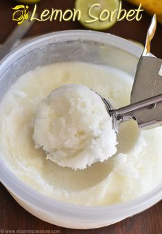 a scoop of lemon sorbet in a bowl with a metal tong on it