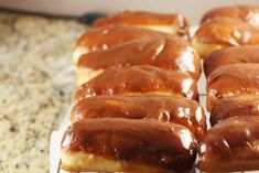 several glazed donuts sitting on top of a cooling rack