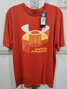 Mens Under Armour Loose Tshirt Size Medium. Under Armour Crew Neck T-shirt With Logo, Red Moisture-wicking T-shirt For Summer, Under Armour Cotton T-shirt With Letter Print, Under Armour Graphic Print Tops For Streetwear, Under Armour Short Sleeve T-shirt With Letter Print, Under Armour Casual Graphic T-shirt, Under Armour Casual Graphic Print T-shirt, Under Armour Crew Neck Top With Letter Print, Casual Under Armour Graphic T-shirt