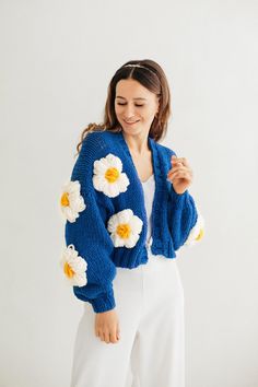 "Flower cardigan bomber jacket. Meet bloom knit jacket super fluffy, chunky knit cardigan! Unique designed long sleeves with flowers. There are large fluffy knitted flowers on the cardigan. When placing an order, you can choose the main color for the sweater and also choose the color for the flowers (these can be white and yellow flowers as in the photo or multi-colored knitted flowers). Oversized sweater would look perfect as part of your look. Hand knitted cardigan can be worn as casual coat f Trendy Blue Sweater Coat For Spring, Trendy Blue Chunky Knit Cardigan, Trendy Blue Acrylic Outerwear, Blue Trendy Acrylic Cardigan, Trendy Blue Acrylic Cardigan, Blue Chunky Knit Cardigan For Winter, Blue Chunky Knit Winter Cardigan, Hand Knitted Trendy Spring Cardigan, Spring Trendy Hand Knitted Cardigan