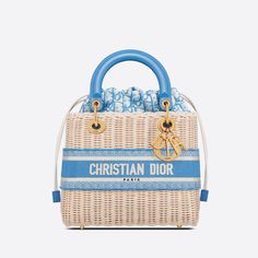 The Lady Dior handbag embodies our idea of elegance and beauty. Crafted from natural-colored, hand-woven wicker, the timeless design is a prime example of Dior's savoir-faire. The pouched style in cornflower blue Dior Oblique jacquard features a drawstring waist and tie at front with "CHRISTIAN DIOR PARIS" embroidery. The "D.I.O.R." metal charms with an antique gold finish add an elegant touch. The medium-sized Lady Dior bag features a wide, detachable leather shoulder strap, allowing it to be c Blue Dior, Lady Dior Handbag, Christian Dior Paris, Dior Oblique, Womens Designer Bags, Christian Dior Fashion, Christian Dior Couture, Jane Birkin, Dior Handbags