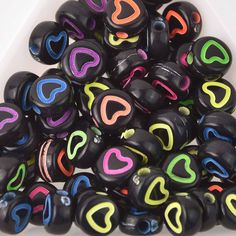 a pile of black and multicolored heart shaped beads