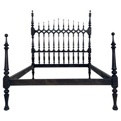 an old iron bed frame with wooden posts and spindles on the headboard, isolated against a white background