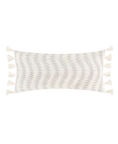 a white and grey pillow with tassels on the front, sitting on a white background