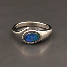 Natural Australian black Opal triplet Sterling Silver Ring, one-off piece of natural opal set in sterling silver in a modern design.  💎 Main Gemstone: Natural Australian Black Opal 💎 Material: Solid British Sterling Silver with rhodium plating.  Please note: All my Australian Opals are one-off pieces so some rings will need to be resized to your size once we receive your order, please allow 4-5 working days for us to resize for you.  The current size for this ring is US 7, UK O. It's free of c Silver Opal Ring With Polished Finish, Formal Sterling Silver Opal Birthstone Ring, Oval Cabochon Opal Ring Gift With Polished Finish, Opal Gifts, Blue Fire Opal, Australian Black Opal, Free Giveaways, Cosmic Consciousness, October Birthday