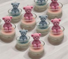 several small crocheted teddy bears sitting in glass cups filled with milk and marshmallows