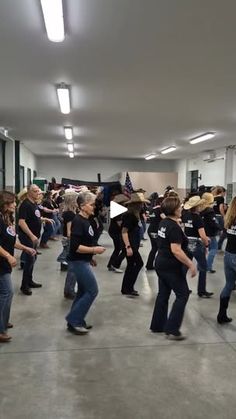 a group of people in jeans and cowboy hats dancing