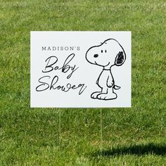 a sign that says madison's baby shower with a cartoon snoopy on it