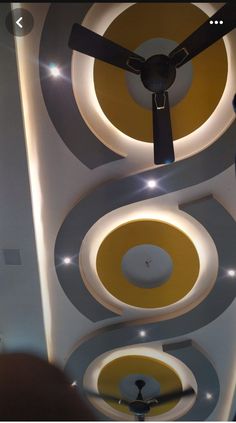 the ceiling is decorated with round lights and circular circles on each side, as well as a clock