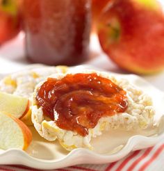 an image of food on a plate with apples in the background