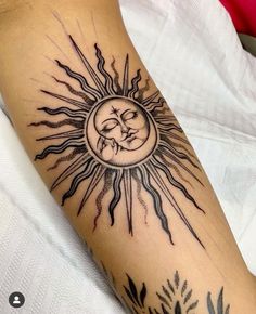 a sun and moon tattoo on the arm