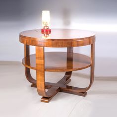 a small wooden table with a light on it's top and shelf underneath the table