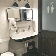 a bathroom with a sink, mirror and toilet