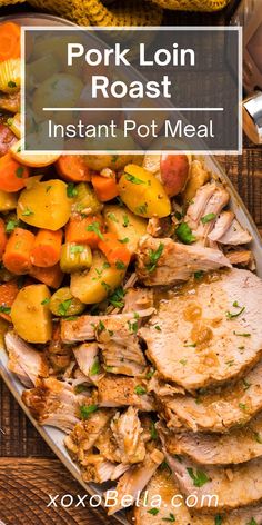 pork loin roast with potatoes and carrots on a plate next to a fork