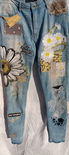 an old pair of jeans with patches and flowers on them