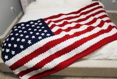 an american flag knitted blanket on top of a bed