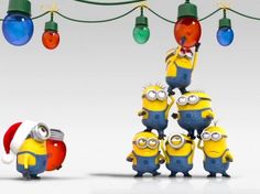 three minion characters are standing in front of christmas lights