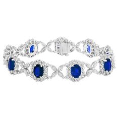 Gorgeous tennis bracelet set with 9 Blue Sapphires surrounded by brilliant cut round diamonds. These Blue Sapphires are linked with flower shape Marquise diamonds. Total weight of the Blue Sapphires is 11.47 carats; Total weight of the round diamonds is 1.36 carats and Marquise diamonds weigh is 2.60 Carat. Made with 14k white gold. All diamonds are GH color SI1 Clarity. Available in Ruby and Emerald as well. Style available in different price ranges. Prices are based on your selection. Please c Luxury Blue Tennis Bracelet For Formal Events, Oval Diamond Bracelet With 17 Jewels, Oval Diamond Cut Cubic Zirconia Bracelets, Dazzling Oval Bracelets For Formal Occasions, Formal Oval Link Cubic Zirconia Diamond Bracelet, Dazzling Oval Diamond Bracelet, Oval Diamond Bracelet With Gemstones, Exquisite Oval Diamond Bracelet, Formal Oval Diamond Cut Bracelets