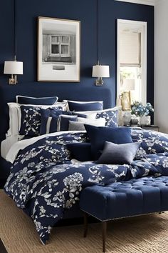 a blue and white bedroom with floral bedding