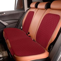 two seats in the back of a car with red carpet and tan leather upholstered