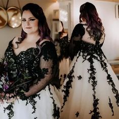 two women dressed in black and white gowns standing next to each other, one holding a bouquet