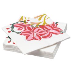 four white napkins with pink flowers and green leaves on them are stacked up in front of each other