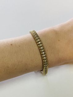 "This is an elegant 14K yellow gold and diamond tennis bracelet. Material(s): 14K yellow gold + (60) diamonds 0.03 points each (Total diamond weight: 2 carats) Weight: 21.1 grams Flaws (if any): None to mention Marking(s): \"14K\" Inside of bracelet measures 7 inches and 5.3 millimeters. If you have any questions about this diamond tennis bracelet, please do not hesitate to contact us! ♥" Formal Yellow Gold Diamond Bracelet With Accents, Hand-set Yellow Gold Diamond Bracelet For Anniversary, Yellow Gold Diamond Bracelet Hand Set For Anniversary, Anniversary Diamond Bracelet In Yellow Gold, Hand-set Diamond Tennis Bracelet In Yellow Gold, Yellow Gold Diamond-accented Bracelet For Anniversary, Timeless Hand Set Yellow Gold Tennis Bracelet, Classic Gold Diamond Bracelet With Diamond Accents, Diamond Tennis Bracelet In Yellow Gold