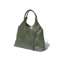 A green tote bag with a 1970's silhouette handcrafted from sustainable leather and lined with 100% Ethiopian cotton. Bohemian Shoulder Bag With Round Handle, Vintage Hobo Bag With Detachable Handle For Everyday, Rectangular Hobo Bag With Brass Hardware For Travel, Vintage Hobo Bag With Gold-tone Hardware, Everyday Rectangular Hobo Bag With Brass Hardware, Rectangular Hobo Bag With Brass Hardware For Everyday, Elegant Rectangular Hobo Bag With Brass Hardware, Elegant Hobo Bag With Brass Hardware For Daily Use, Chic Hobo Bag With Brass Hardware For Everyday Use