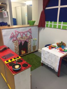 a child's playroom with toys and decorations on the walls, including a toy stove