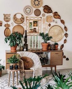 a room filled with lots of plants and pictures on the wall