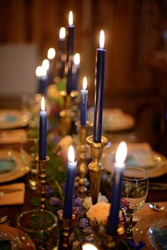 a table with candles and plates on it