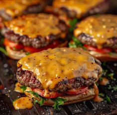 hamburgers with cheese and tomatoes on a grill