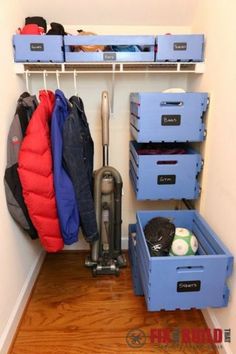 the closet is organized with blue bins and plastic containers, including one for cleaning