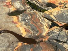 an aerial view of rocks with water in the middle