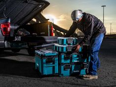 a man is unloading boxes from the back of a truck