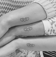 two women with matching tattoos on their arms