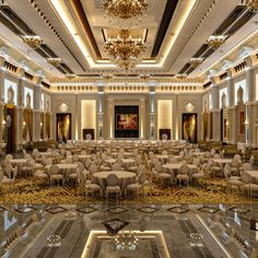 a banquet hall with tables and chairs set up for a formal function